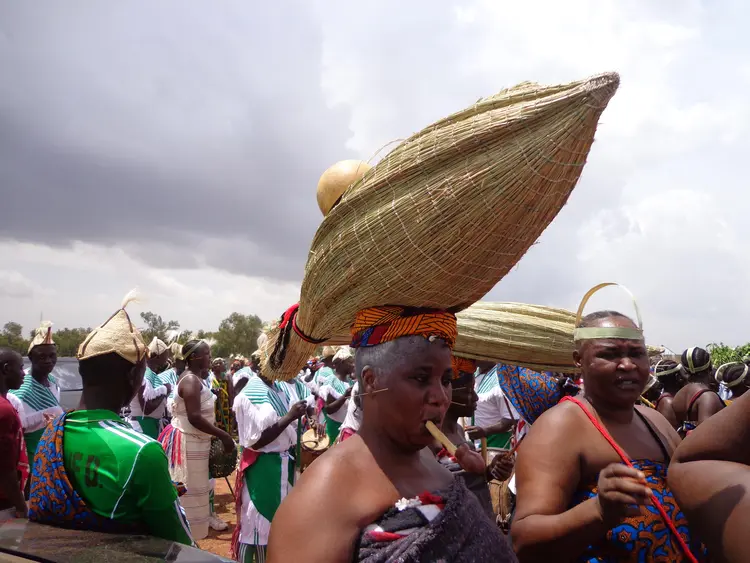 Woman dancing with local Umbrella (Mat nkaa cin kook ki Kuluk)