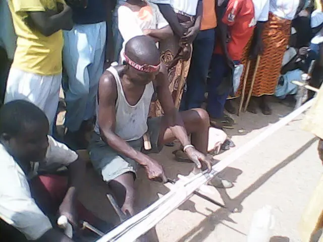 Mwaghavul Man weaving clothe materials