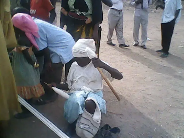 Mwaghavul Woman twisting threads for weaving clothe materials